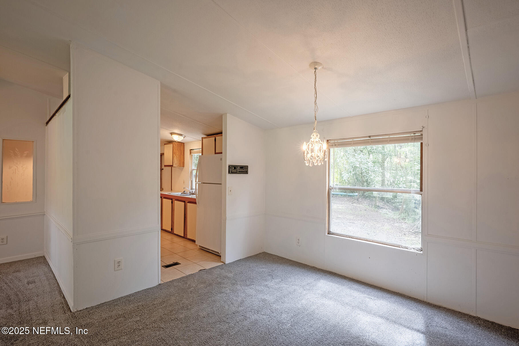 8105 Colee Cove Road St. Augustine, FL 32092 - Photo 15 of 44 a view of a room with window and refrigerator