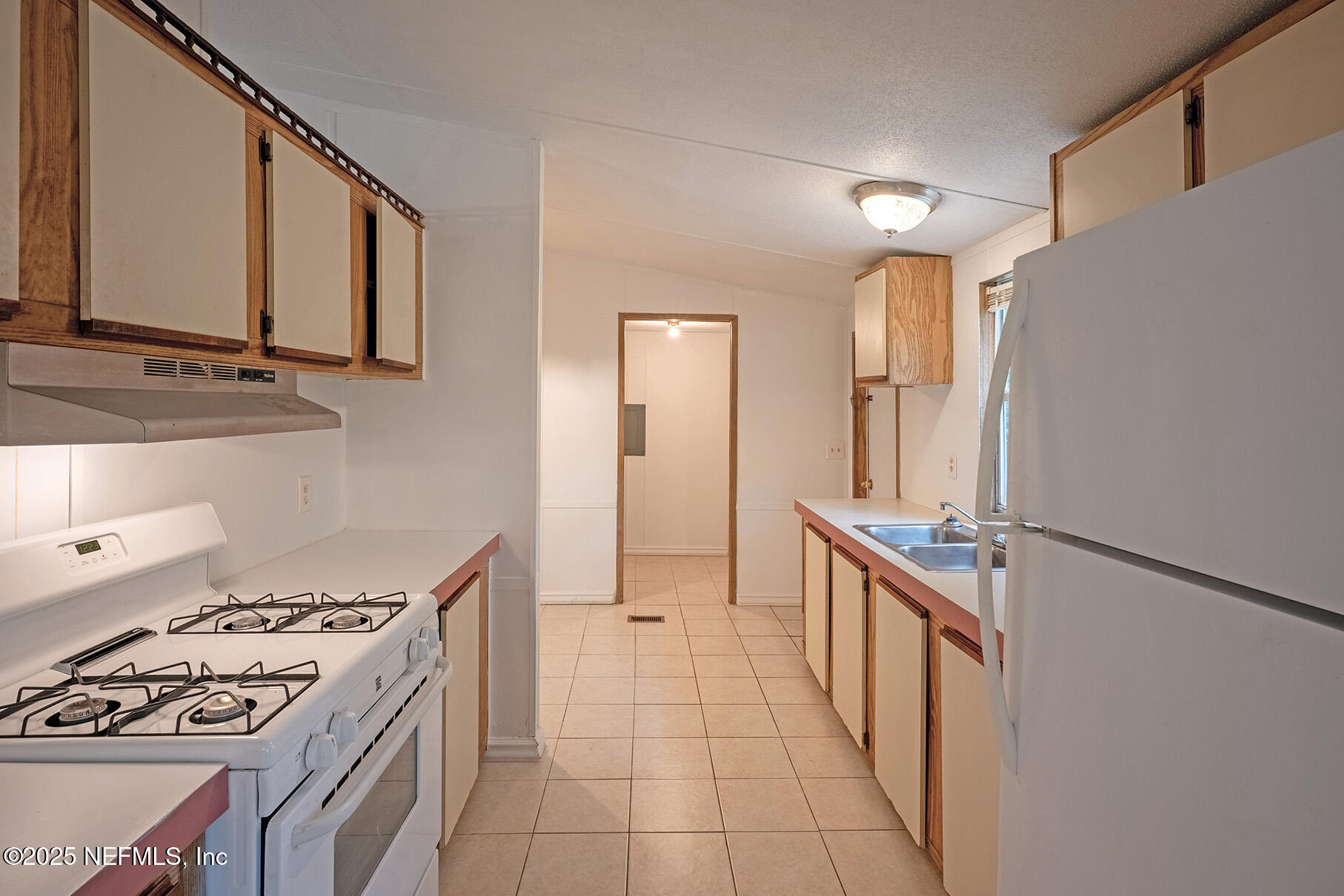 8105 Colee Cove Road St. Augustine, FL 32092 - Photo 17 of 44 a kitchen with stainless steel appliances a stove a sink and a refrigerator
