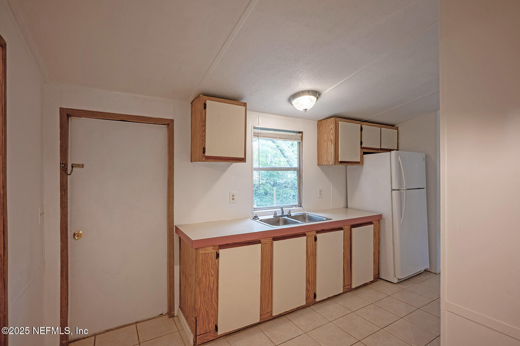 8105 Colee Cove Road St. Augustine, FL 32092 - Photo 21 of 44 a kitchen with stainless steel appliances granite countertop a sink and a refrigerator