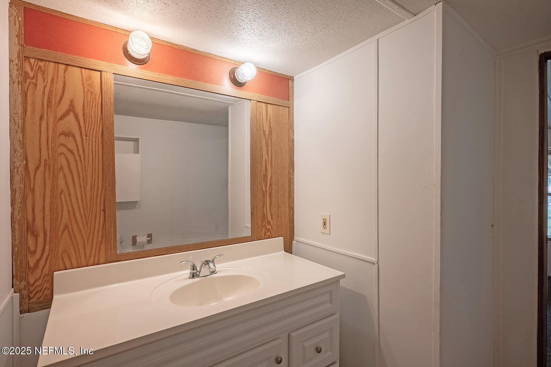 8105 Colee Cove Road St. Augustine, FL 32092 - Photo 34 of 44 a bathroom with a sink and a mirror