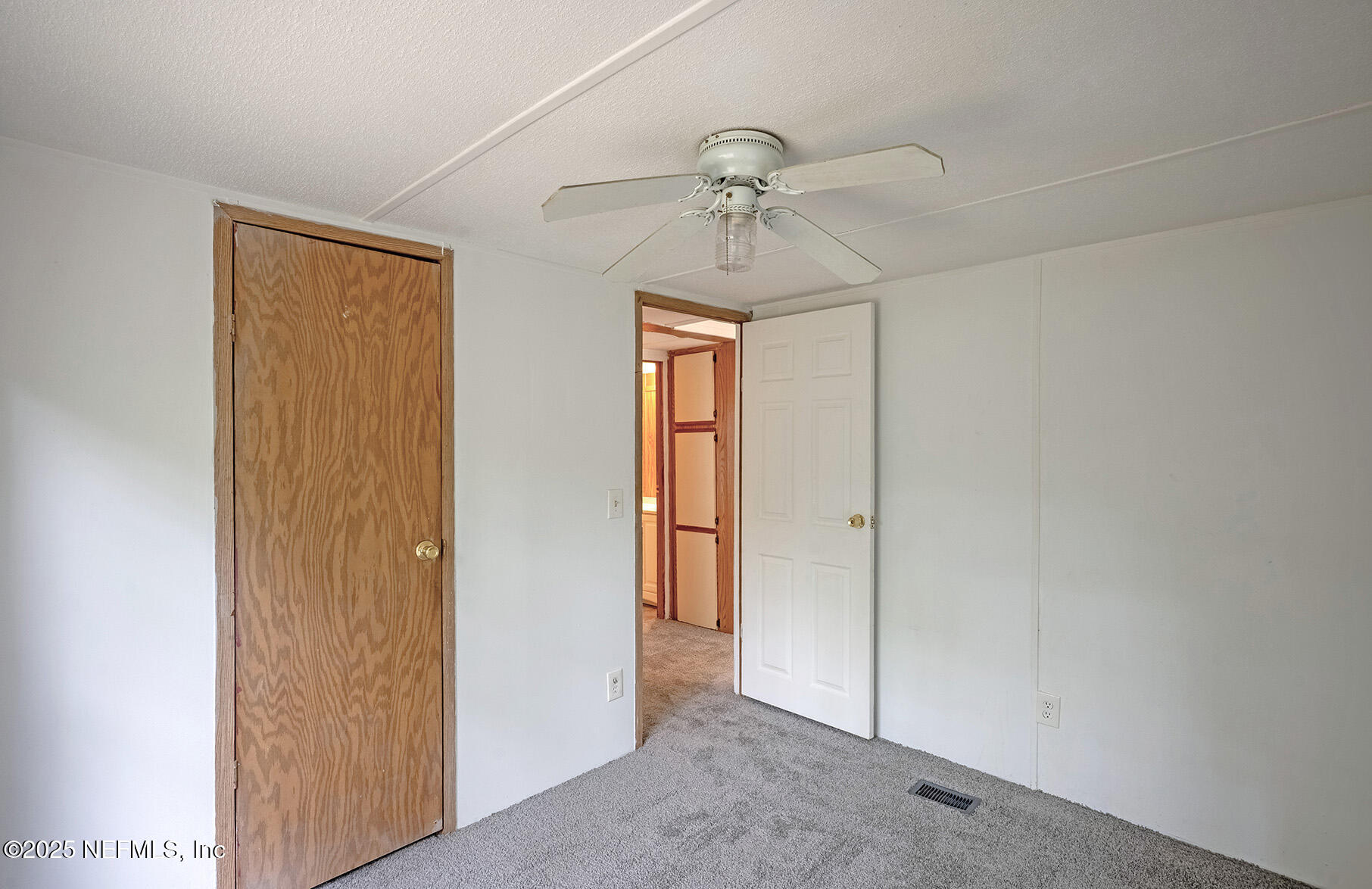 8105 Colee Cove Road St. Augustine, FL 32092 - Photo 36 of 44 an empty room with windows and fan