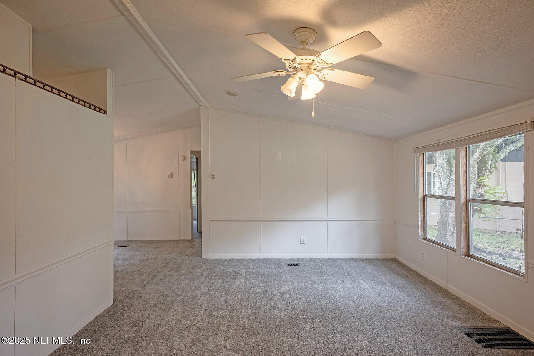 8105 Colee Cove Road St. Augustine, FL 32092 - Photo 8 of 44 an empty room with windows and fan