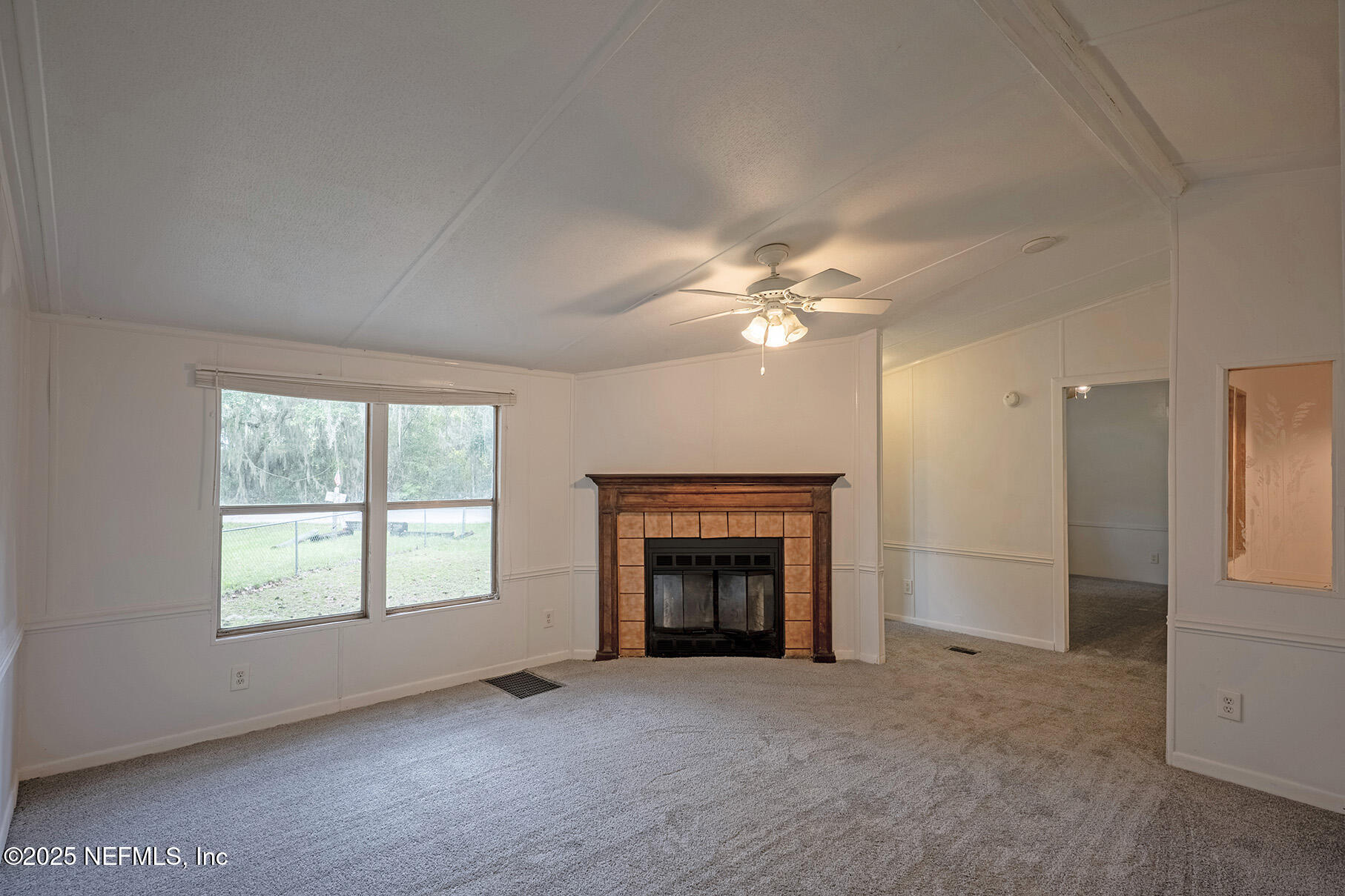 8105 Colee Cove Road St. Augustine, FL 32092 - Photo 10 of 44 an empty room with windows and fireplace