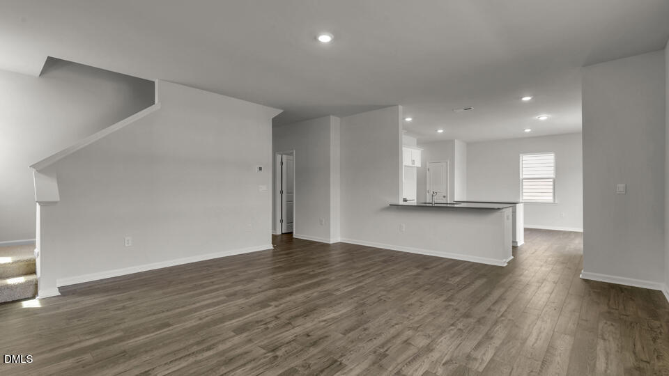 1316 Pavo Path Wendell, NC 27591 - Photo 11 of 54 a view of an empty room with wooden floor and a window
