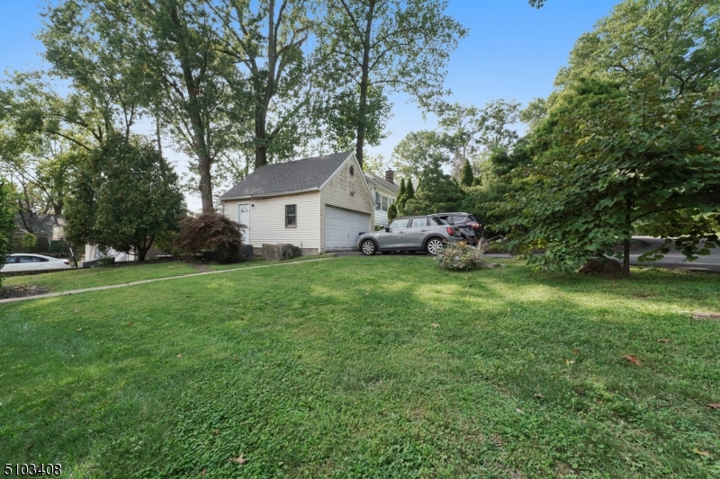 759 Ridgewood Road Millburn, NJ 07041 - Photo 15 of 16 a view of a house with a yard and sitting area
