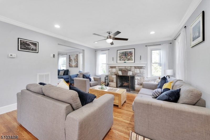 759 Ridgewood Road Millburn, NJ 07041 - Photo 3 of 16 a living room with furniture a fireplace and a large window