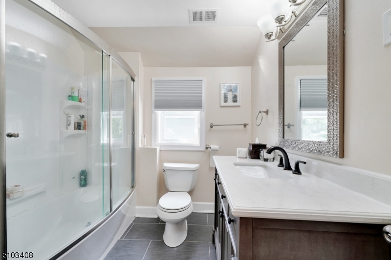759 Ridgewood Road Millburn, NJ 07041 - Photo 10 of 16 a bathroom with a sink a toilet and shower