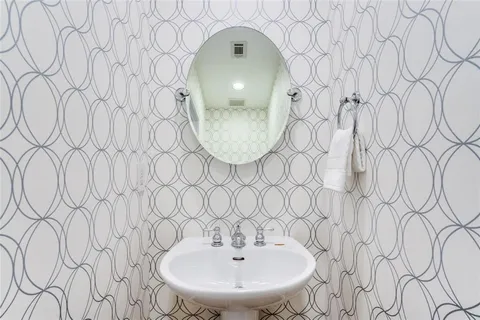a view of a balcony with wooden floor and iron fence