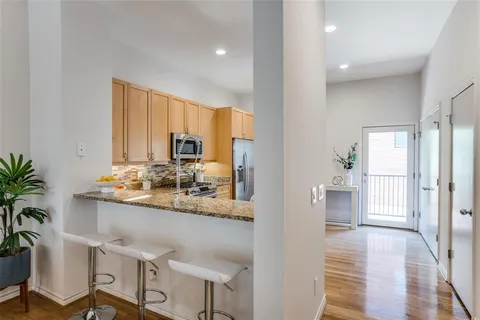 a kitchen with counter top space and wooden floor