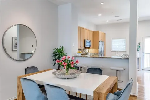 a dining room with furniture and wooden floor