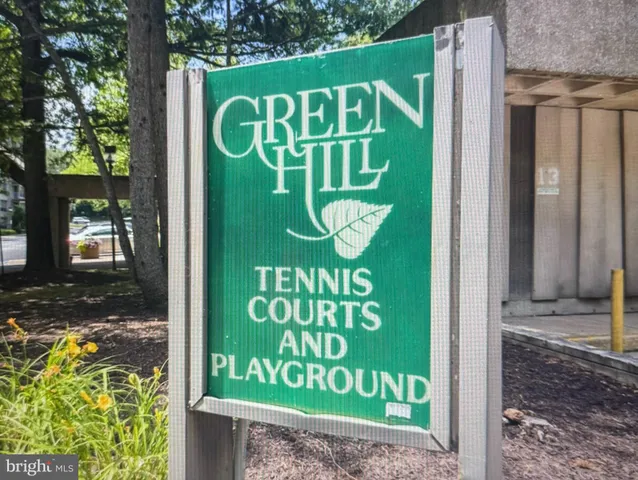 a kitchen with stainless steel appliances granite countertop a sink dishwasher a refrigerator and wooden cabinets