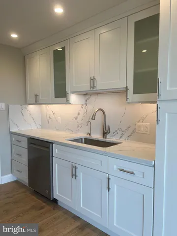 a view of a kitchen with a sink and a stove top oven