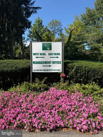 a view of a balcony with a table and chairs and potted plants