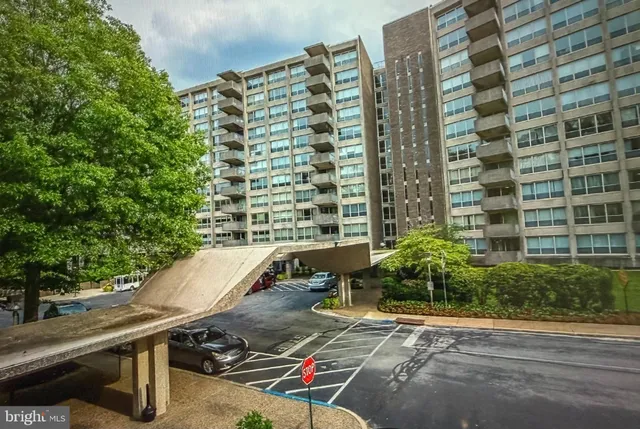 a view of a patio with table and chairs under an umbrella