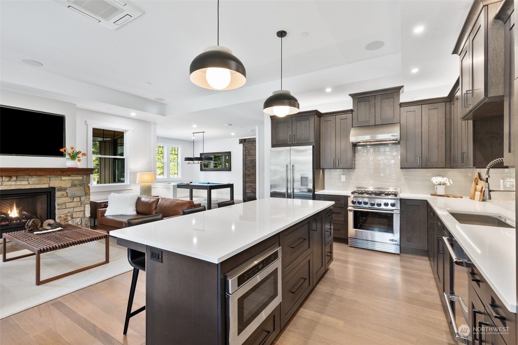 677 Larkspur Loop Cle Elum, WA 98922 - Photo 11 of 38 a large kitchen with kitchen island a large island in the center a sink a stove and a center island