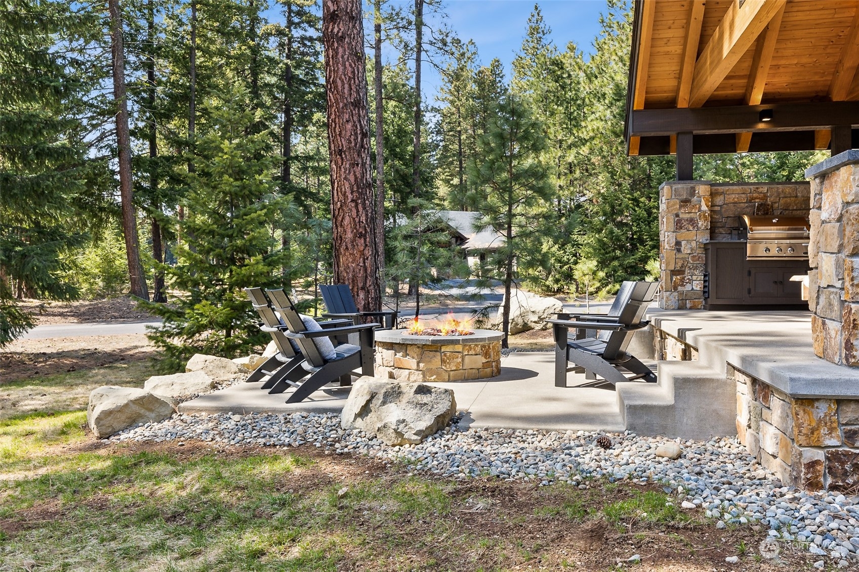 677 Larkspur Loop Cle Elum, WA 98922 - Photo 30 of 38 a view of a patio with a table and chairs under an umbrella