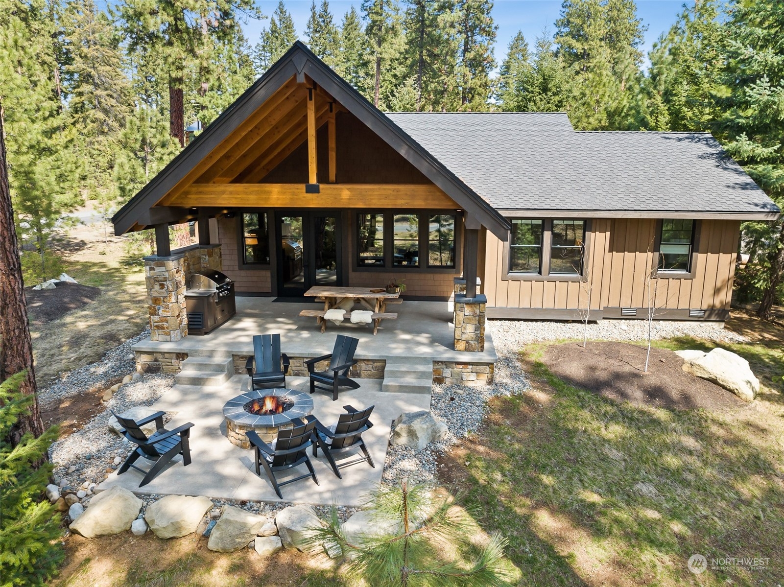 677 Larkspur Loop Cle Elum, WA 98922 - Photo 32 of 38 a backyard of a house with table and chairs