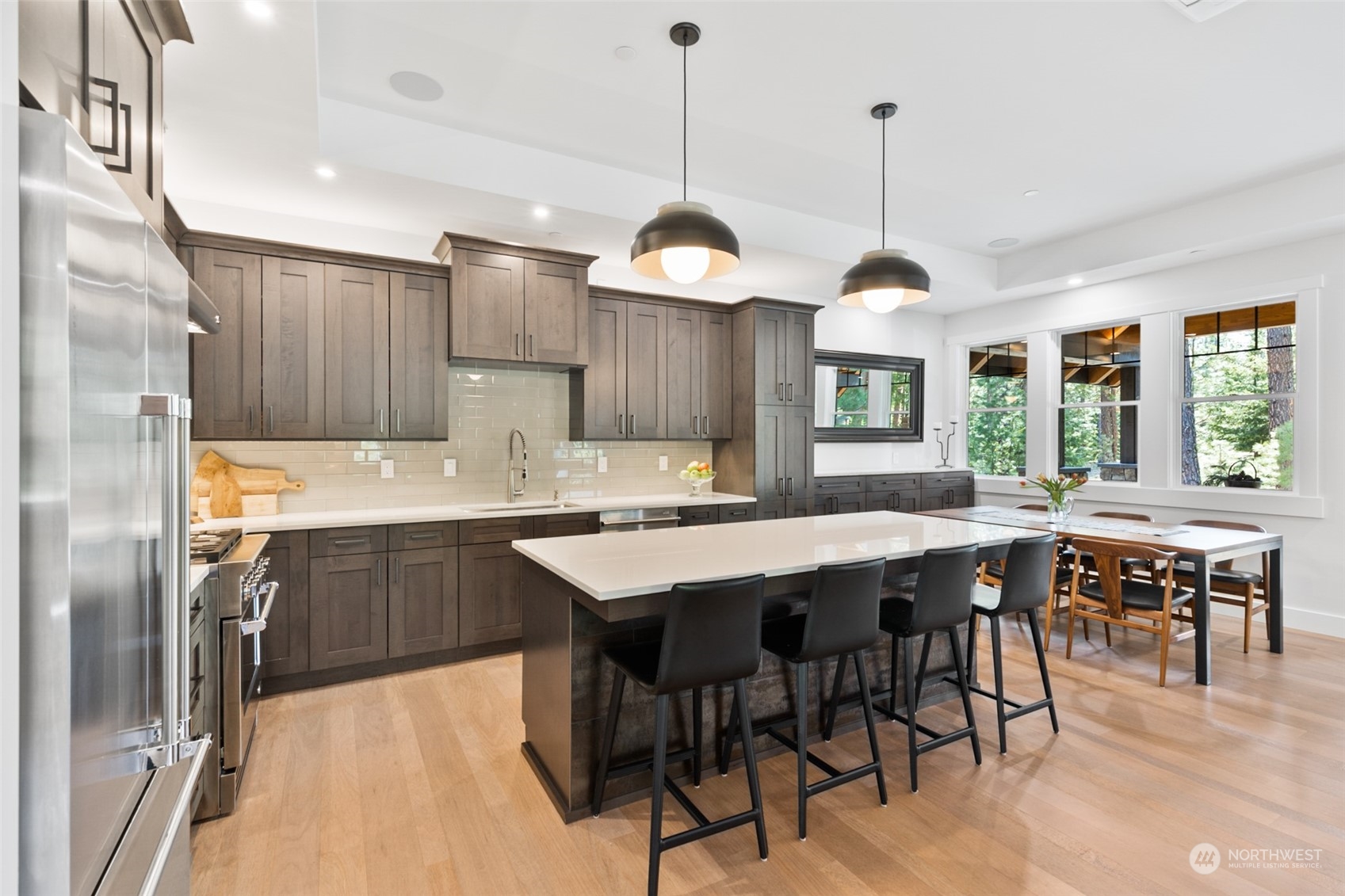 677 Larkspur Loop Cle Elum, WA 98922 - Photo 9 of 38 a kitchen with stainless steel appliances granite countertop a kitchen island a stove a table and chairs
