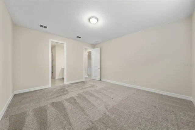 a bathroom with a double vanity sink a large mirror and shower