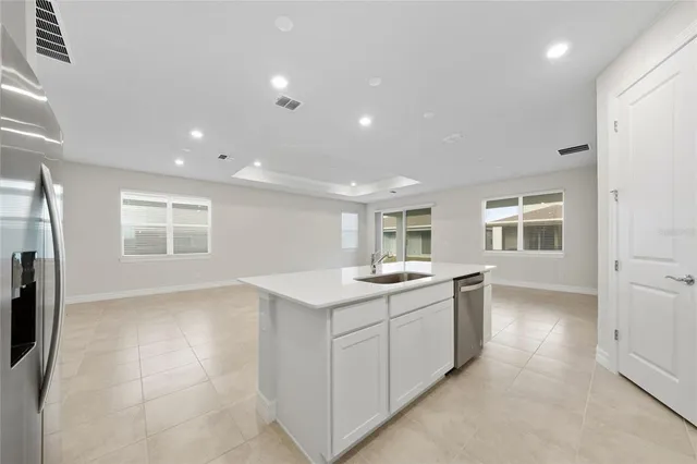 a view of kitchen with kitchen island refrigerator stove microwave and cabinets