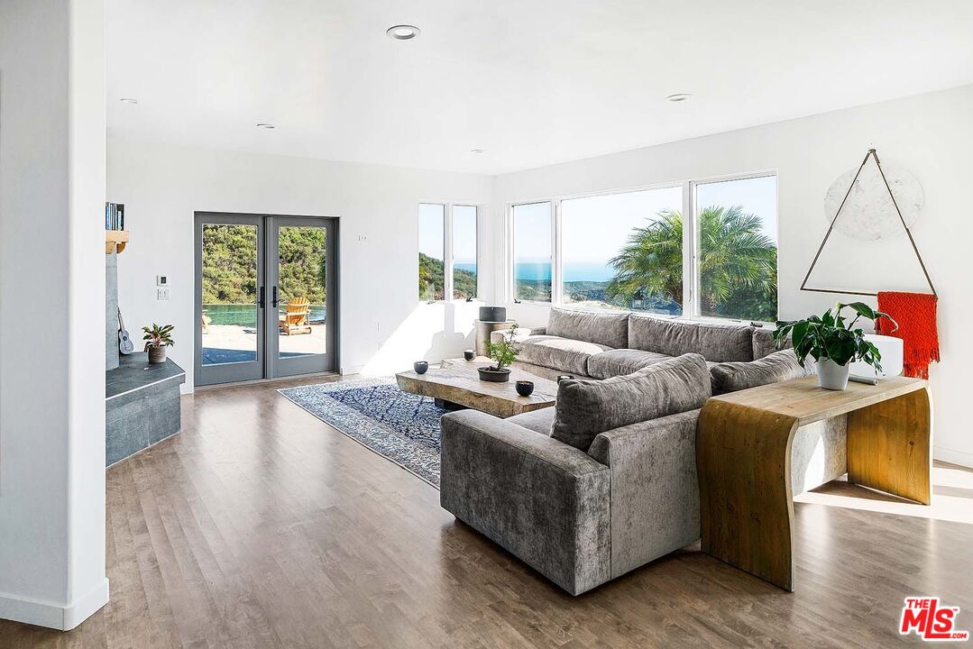 20370 Skyhawk Lane Topanga, CA 90265 - Photo 11 of 43 a living room with furniture and a wooden floor