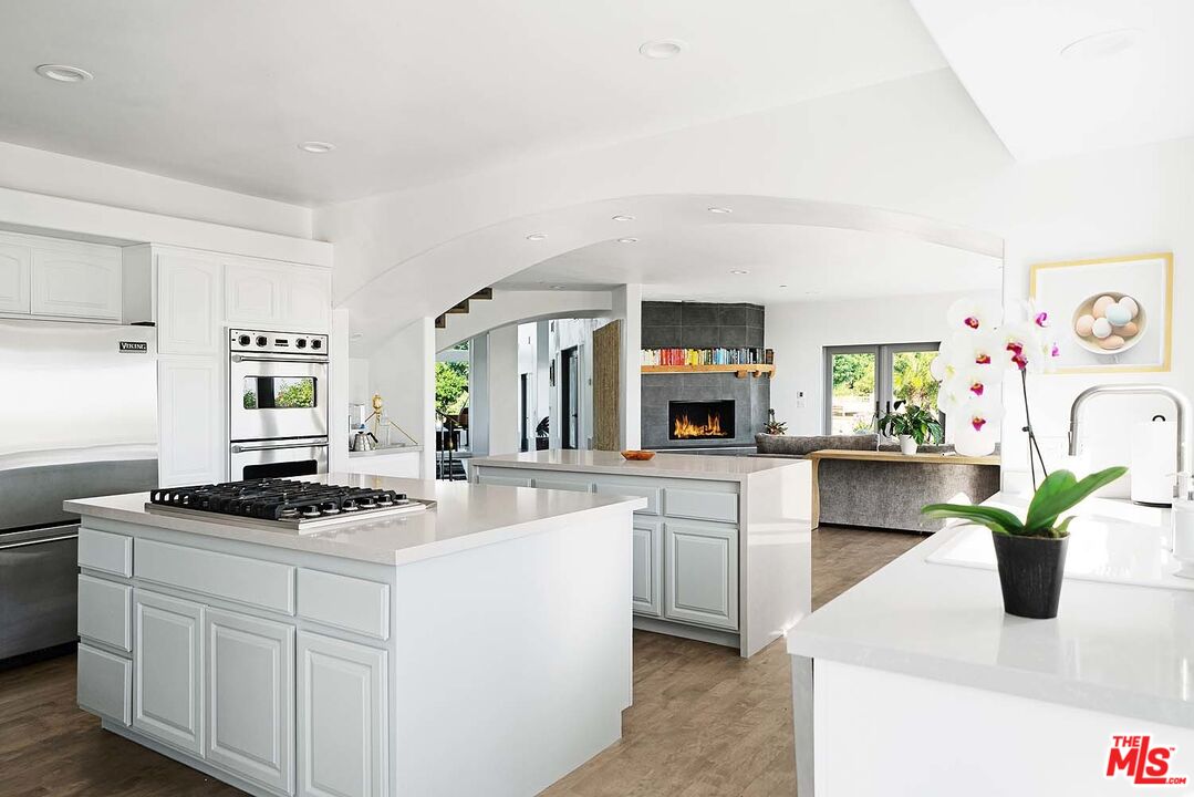 20370 Skyhawk Lane Topanga, CA 90265 - Photo 14 of 43 a kitchen with white cabinets and a stove