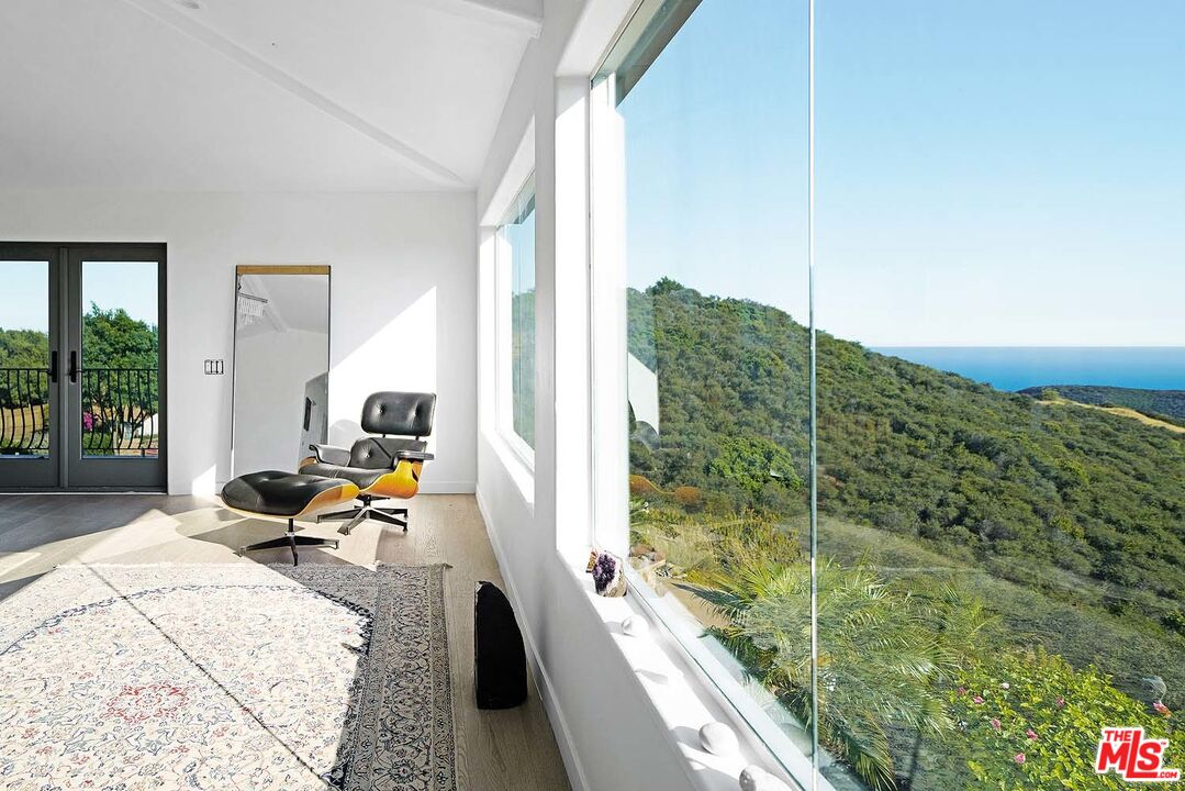 20370 Skyhawk Lane Topanga, CA 90265 - Photo 17 of 43 a bedroom with a bed and large windows