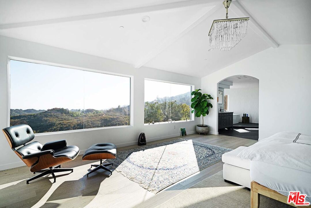 20370 Skyhawk Lane Topanga, CA 90265 - Photo 18 of 43 a living room with furniture fireplace and a large window