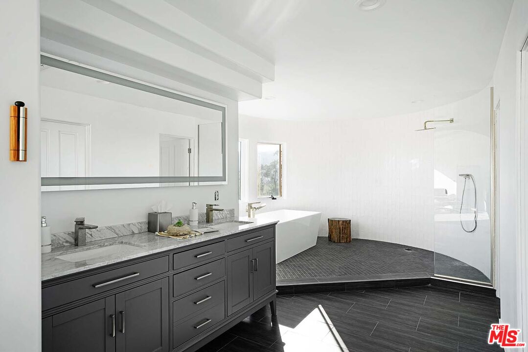 20370 Skyhawk Lane Topanga, CA 90265 - Photo 23 of 43 a spacious bathroom with a double vanity sink and mirror