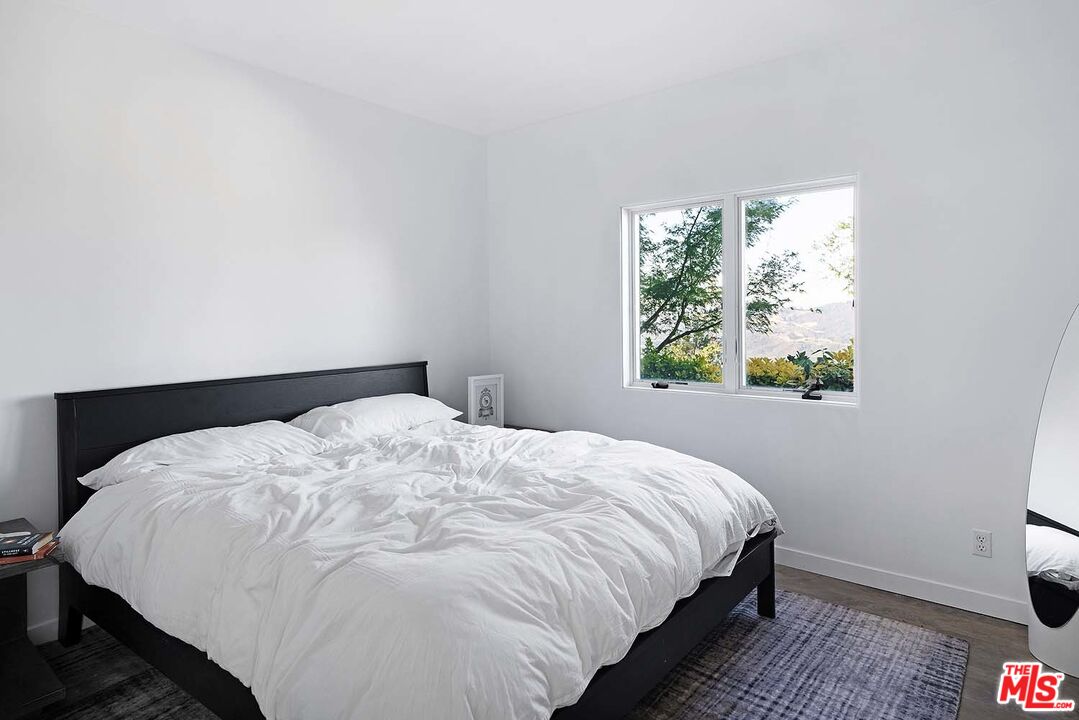 20370 Skyhawk Lane Topanga, CA 90265 - Photo 24 of 43 a large bed sitting in a bedroom next to a window