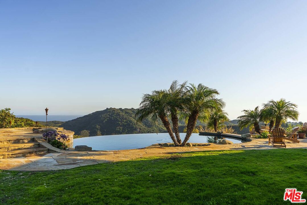 20370 Skyhawk Lane Topanga, CA 90265 - Photo 27 of 43 a view of a swimming pool with an outdoor space and seating area