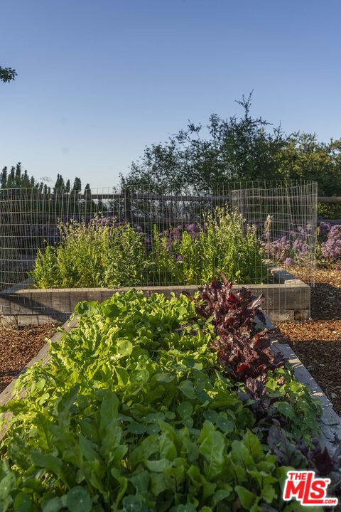 20370 Skyhawk Lane Topanga, CA 90265 - Photo 32 of 43 a view of a lake with a house in the background