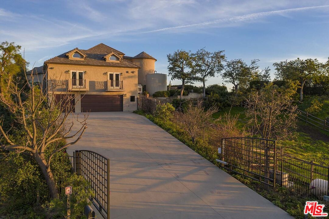 20370 Skyhawk Lane Topanga, CA 90265 - Photo 41 of 43 a front view of a house with a yard
