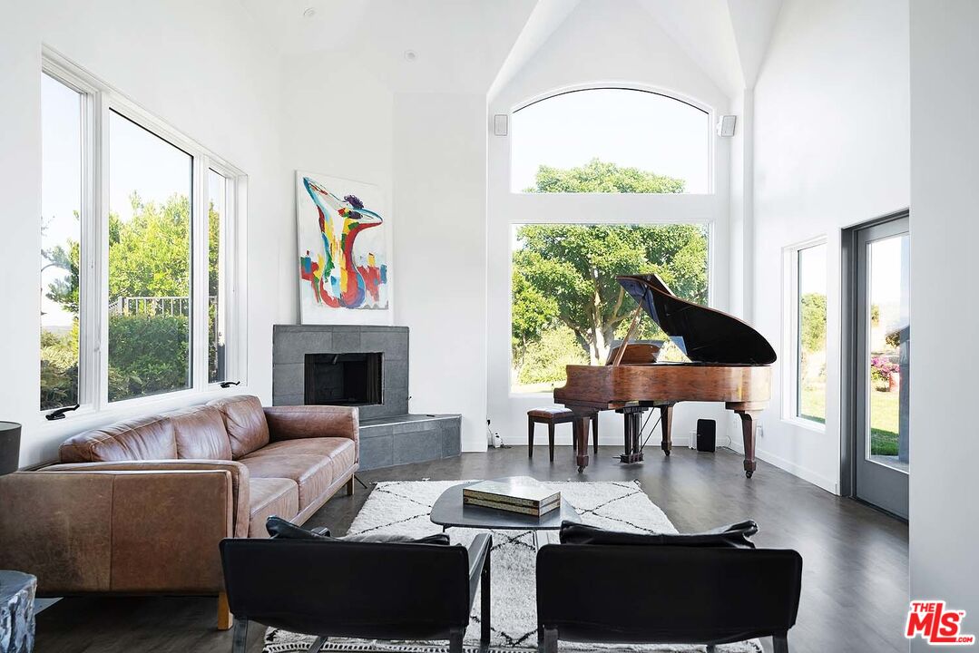 20370 Skyhawk Lane Topanga, CA 90265 - Photo 5 of 43 a living room with furniture and a large window