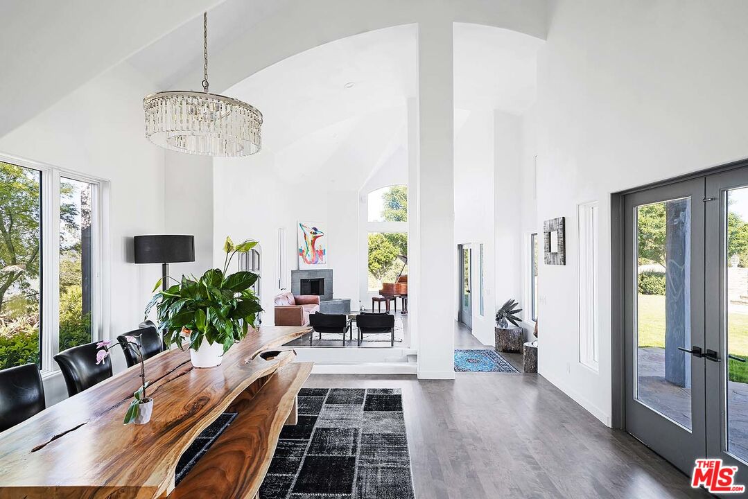 20370 Skyhawk Lane Topanga, CA 90265 - Photo 7 of 43 a living room with furniture and a chandelier