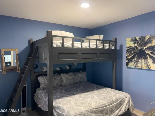 a view of a city from a dining room with furniture and a potted plant