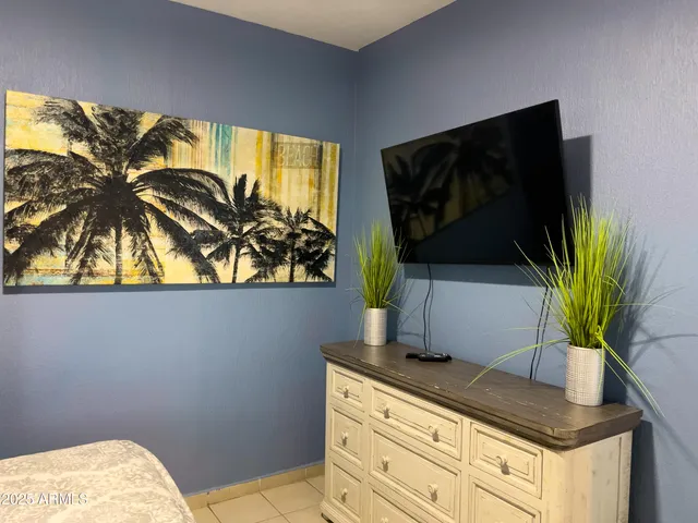 a view of a dining room with furniture and a chandelier