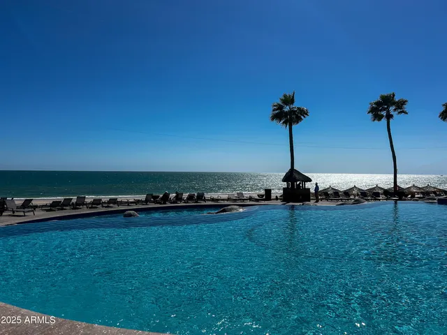 a swimming pool with outdoor seating and yard