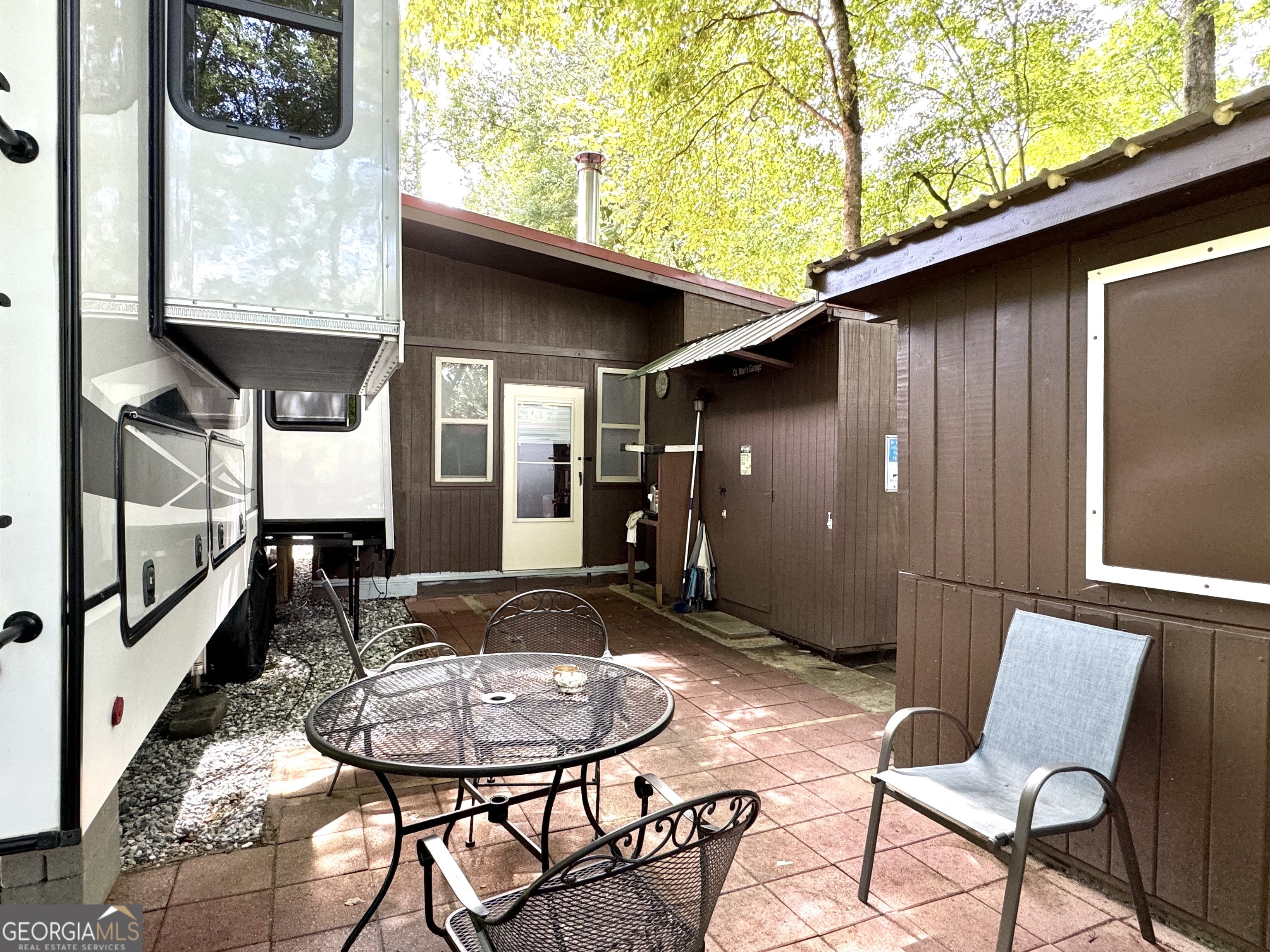279 Leisure Acres Drive Cleveland, GA 30528 - Photo 29 of 40 a view of a patio with table and chairs with wooden floor and plants