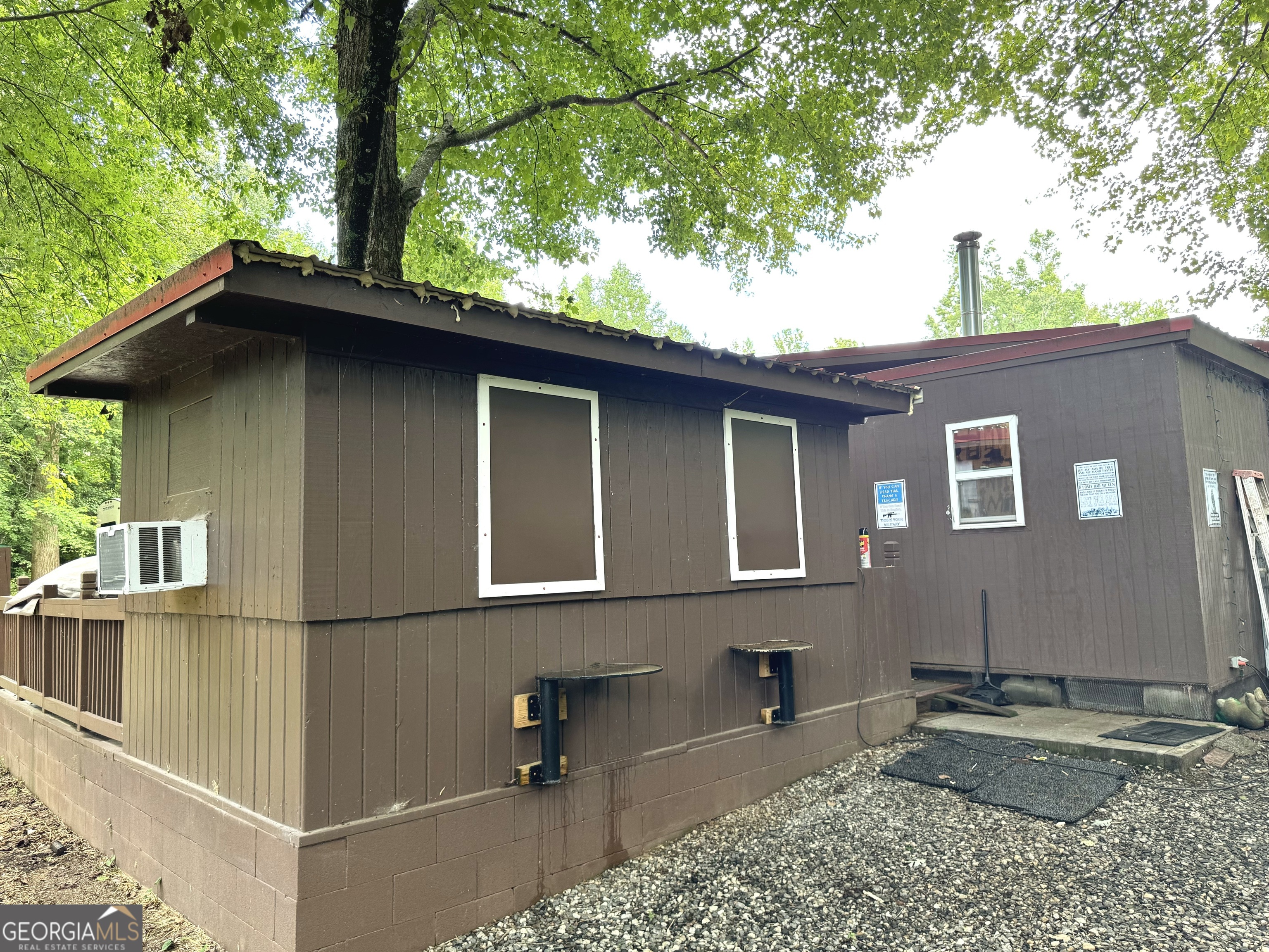 279 Leisure Acres Drive Cleveland, GA 30528 - Photo 36 of 40 a brick house with large windows and potted plants