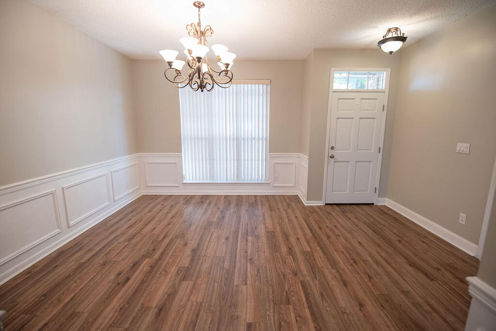 4565 Parkwood Court Niceville, FL 32578 - Photo 12 of 48 a view of an empty room with wooden floor