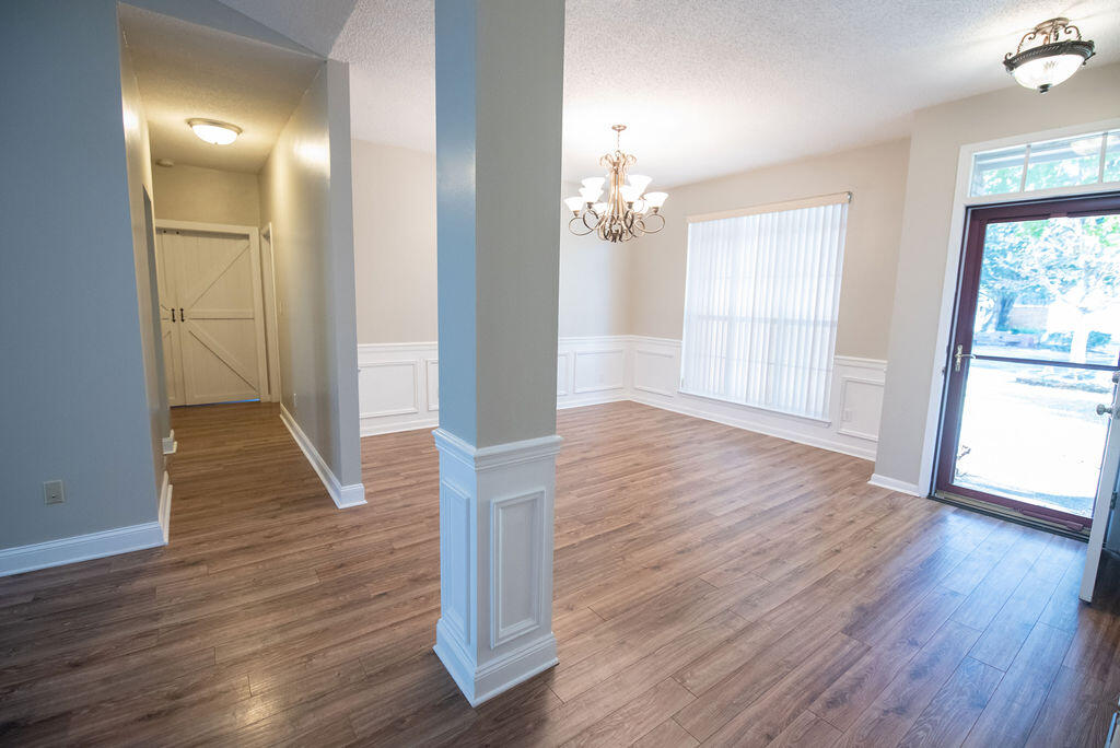 4565 Parkwood Court Niceville, FL 32578 - Photo 13 of 48 an empty room with wooden floor and windows