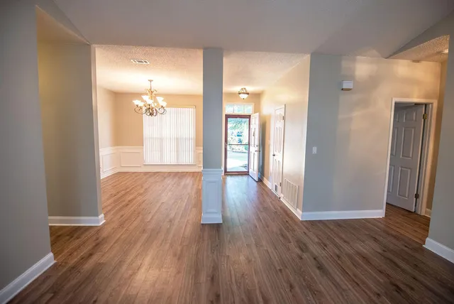 a view of a hallway with wooden floor