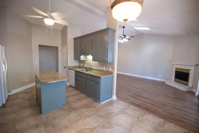 a kitchen with kitchen island cabinets and oven