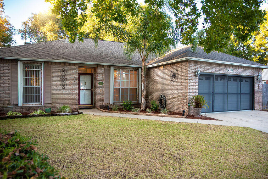 4565 Parkwood Court Niceville, FL 32578 - Photo 2 of 48 a front view of a house with a yard and garage