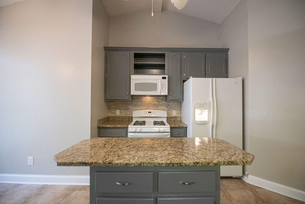4565 Parkwood Court Niceville, FL 32578 - Photo 23 of 48 a kitchen with stainless steel appliances granite countertop a sink and a refrigerator