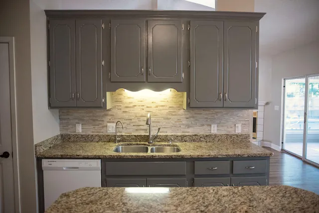 a kitchen with granite countertop wooden cabinets and a granite counter top