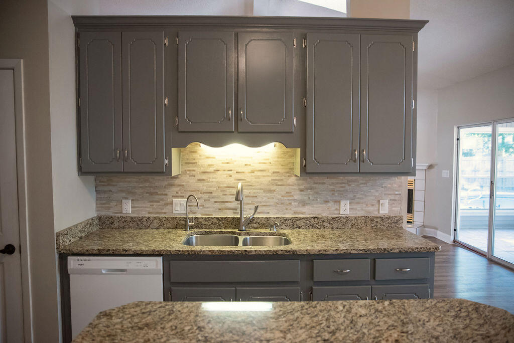 4565 Parkwood Court Niceville, FL 32578 - Photo 24 of 48 a kitchen with granite countertop wooden cabinets and a granite counter top