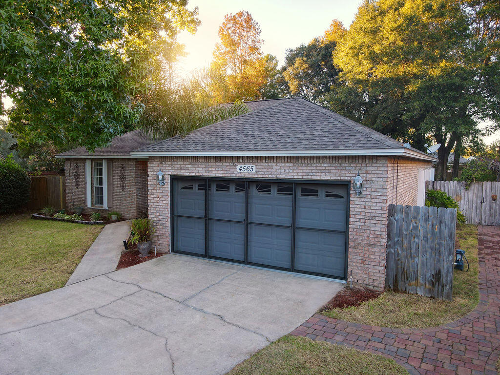 4565 Parkwood Court Niceville, FL 32578 - Photo 3 of 48 a front view of a house with a yard and garage