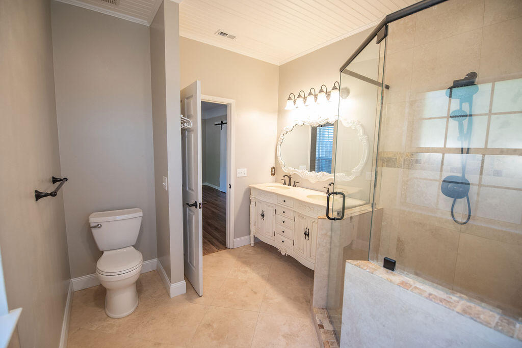 4565 Parkwood Court Niceville, FL 32578 - Photo 33 of 48 a bathroom with a toilet sink shower and mirror
